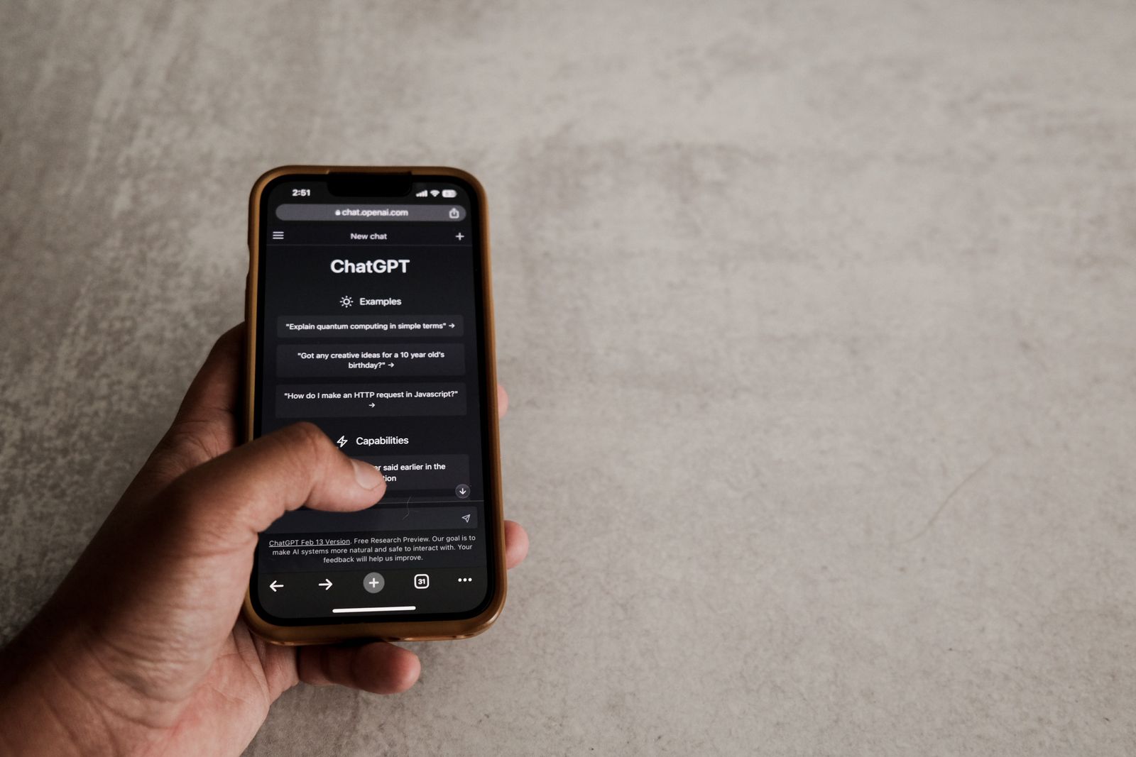 Person chatting with an AI assistant on a smartphone, the kind of search that answer engine optimization targets