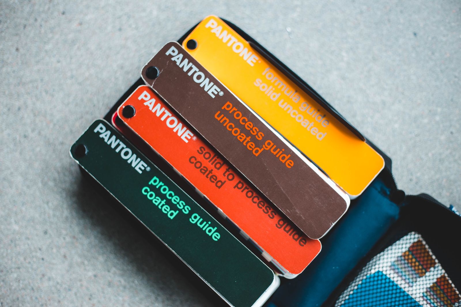 Pantone colour guides fanned out for brand identity work, the branding half of the branding vs marketing decision