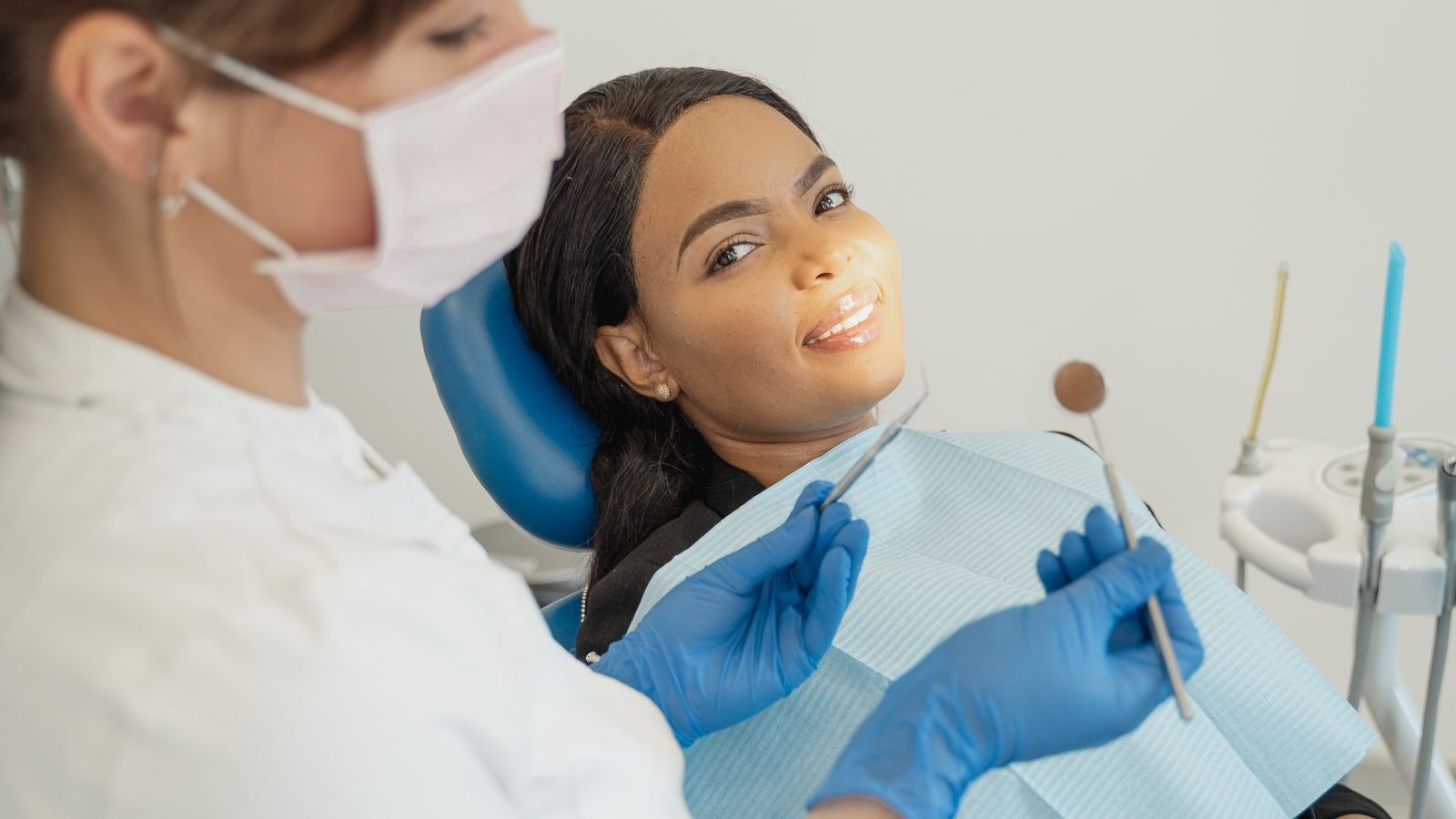 A dentist treating a smiling patient in a modern dental clinic