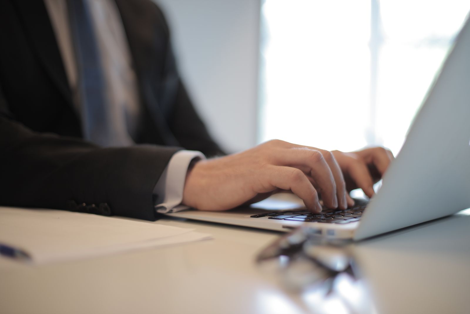 Business owner typing on a laptop, planning email marketing for small business customers in India