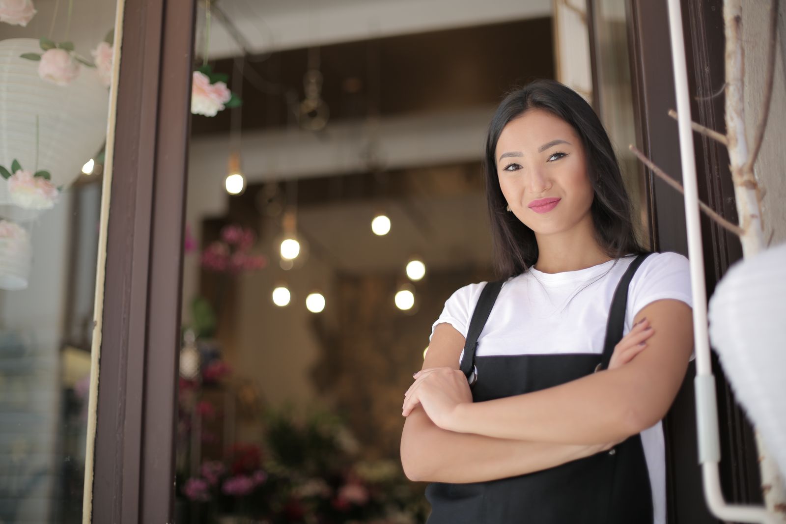 Small business owner standing at her shop entrance, the kind of local business a proper Google Business Profile setup helps customers find