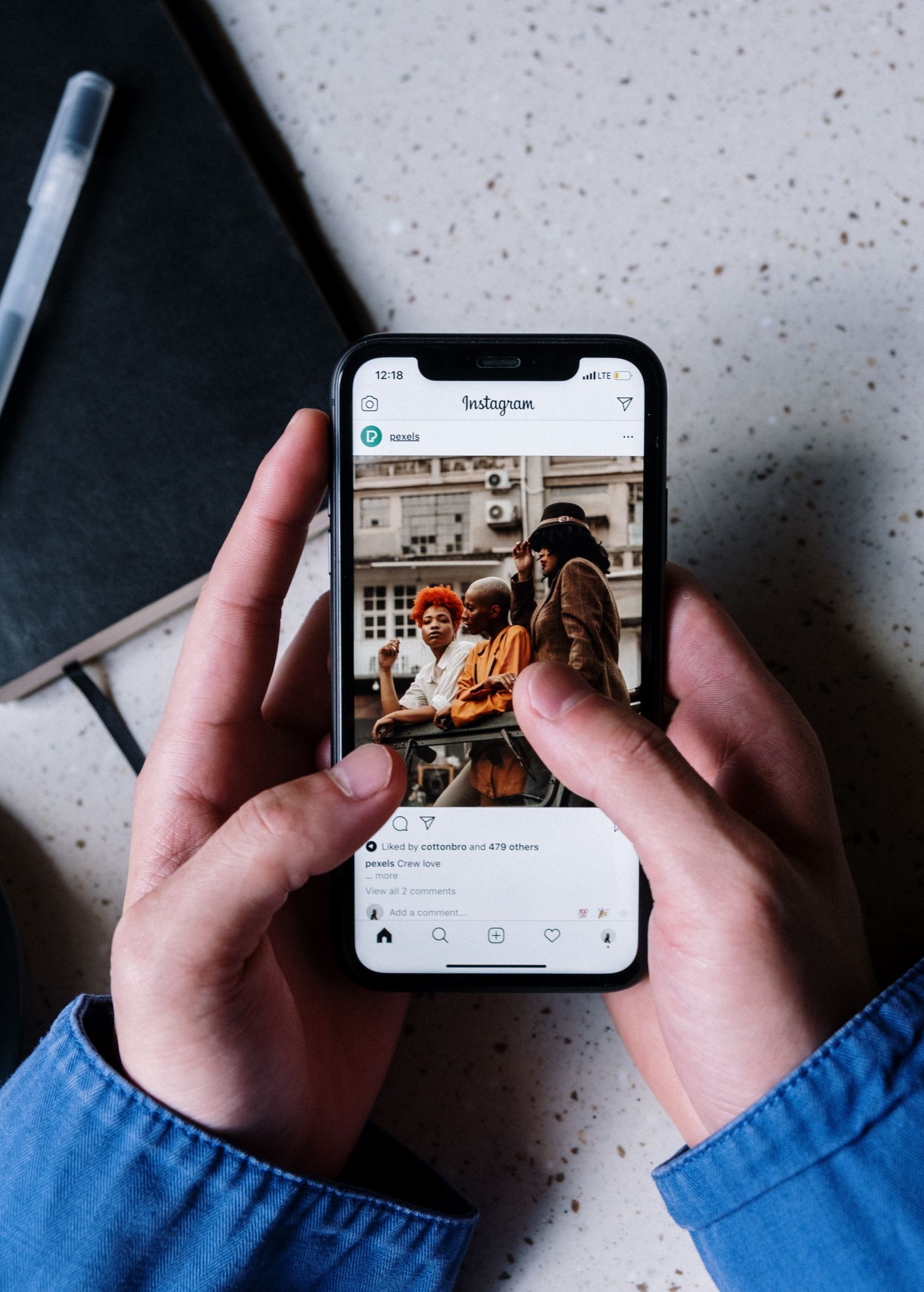 Business owner holding a phone showing Instagram, illustrating instagram marketing for small business