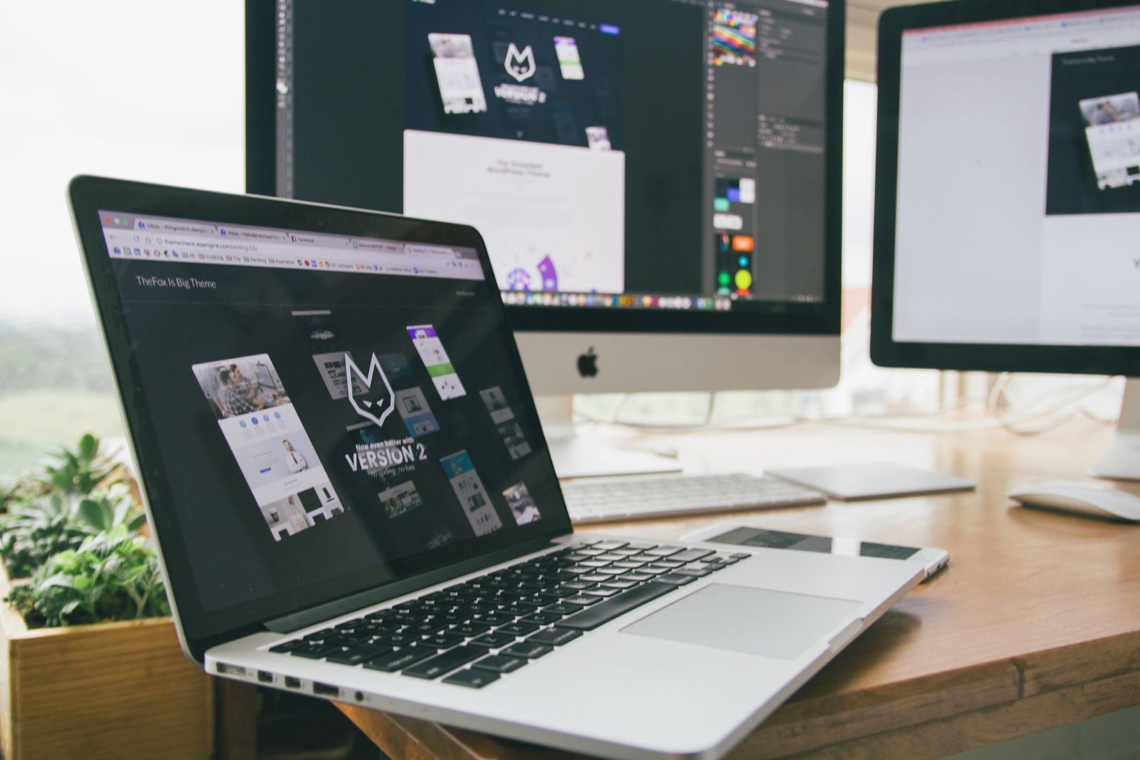 Designer reviewing a website layout on a laptop, working through the elements that drive landing page conversion