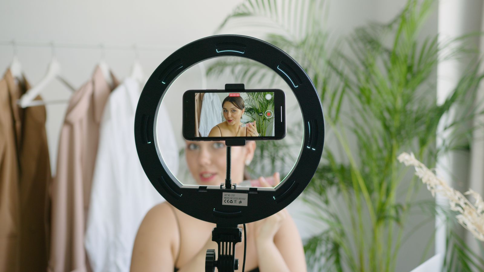 Person filming a short video on a phone, the starting point for diagnosing reels getting low views