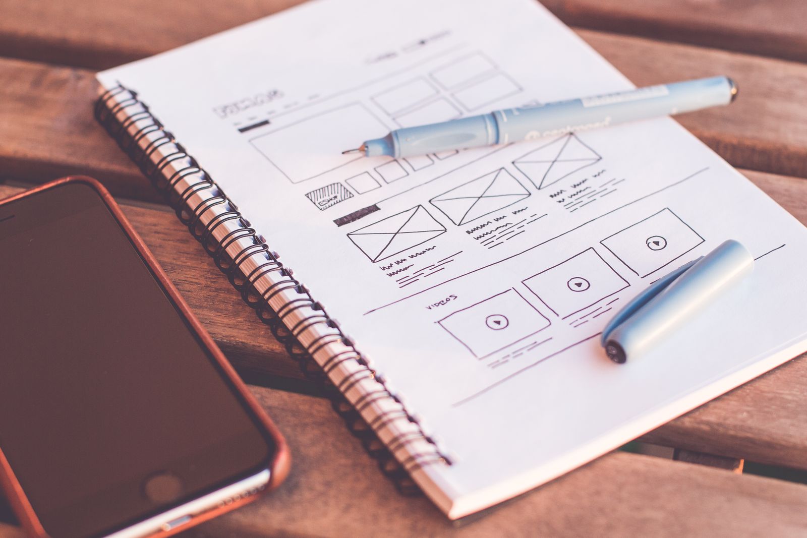 Designer sketching wireframes on paper, the first step in a website redesign checklist